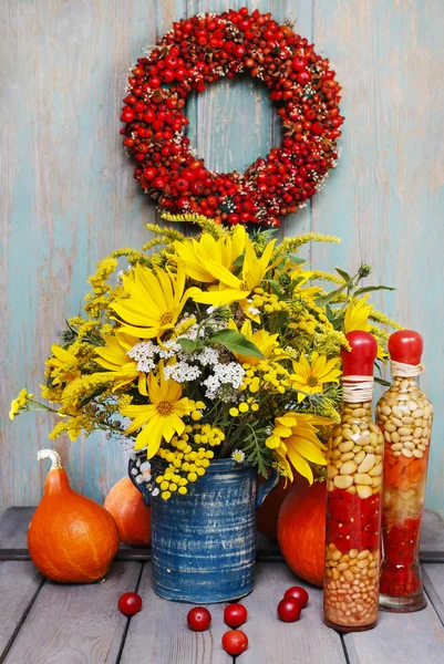 Bouquet of sunflowers and wild flowers on wood