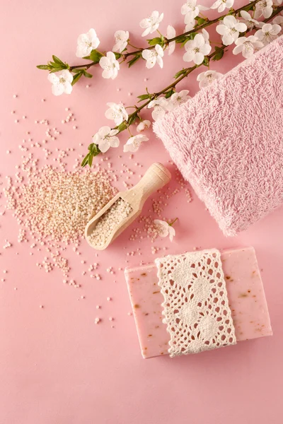 Pink spa set: bar of handmade soap, sea salt and towel. Blooming
