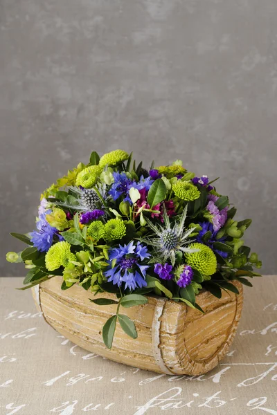 Floral arrangement with blue cornflowers, green chrysanthemums a