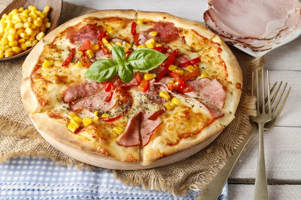 Pizza with ham, corn and pepper