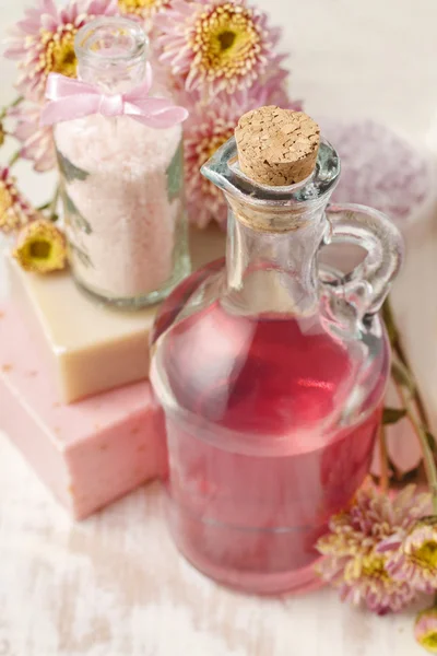 Bottle of pink liquid soap and bottle of sea salt