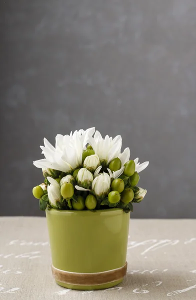 Floral arrangement with white dahlia flowers and green hypericum