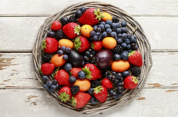 Basket of fruits: strawberries, blueberries, blackberries, grape