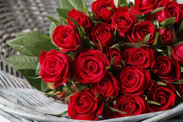 Bouquet of red roses in wicker basket