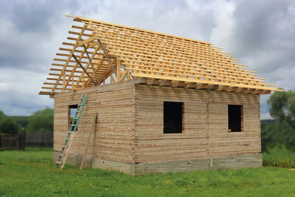 Timber house under constructoin with roof frame
