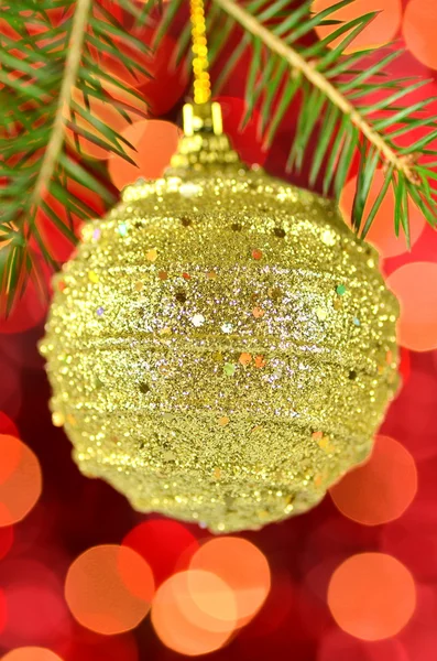 Christmas decoration, Christmas ball hanging on spruce twig against bokeh background