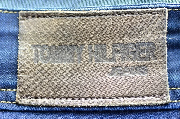 Closeup of Tommy Hilfiger label on blue jeans