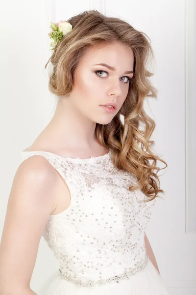 Beauty woman with wedding hairstyle and makeup. Bride fashion.