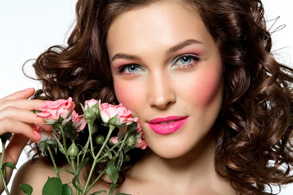 Portrait of beautiful young woman with flowers. Perfect makeup.