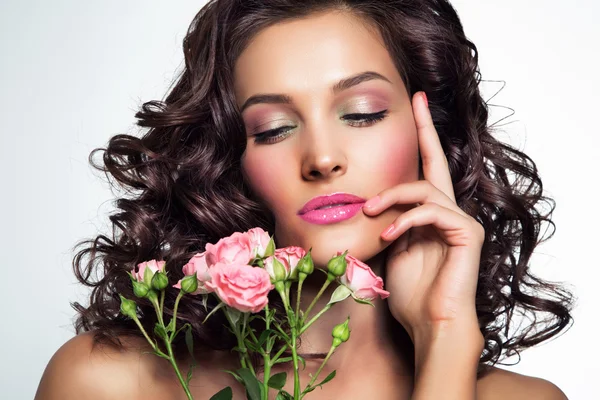 Portrait of beautiful young woman with flowers. Perfect makeup.