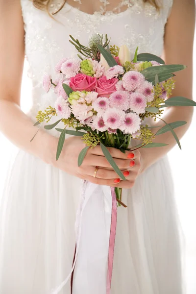 Flowers in the hands of the bride. Bride fashion.