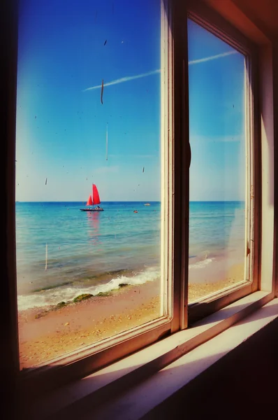 View from the window of an old thrown house on a boat with red s