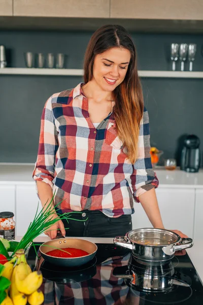 Girl is preparing spaghetti bolognese.