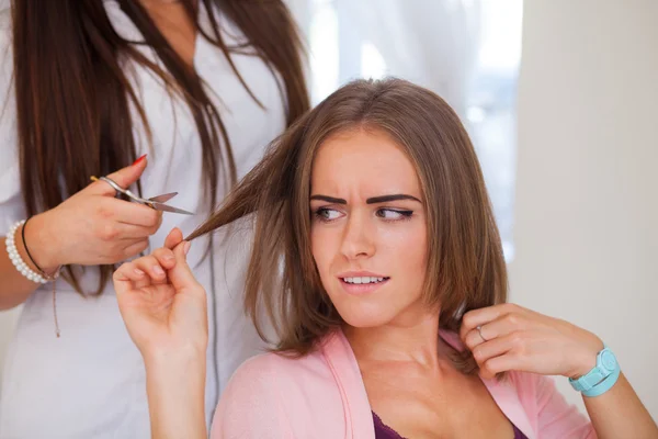 Hairdresser doing haircut for woman