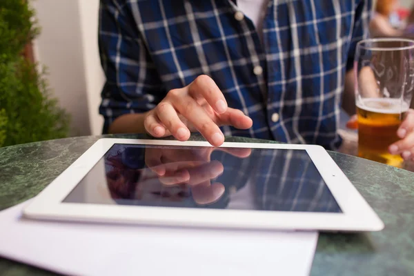 Finger pointing to screen of a tablet-pc.