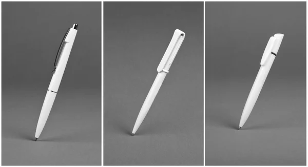 Set of white plastic ballpoint pen on a grey background