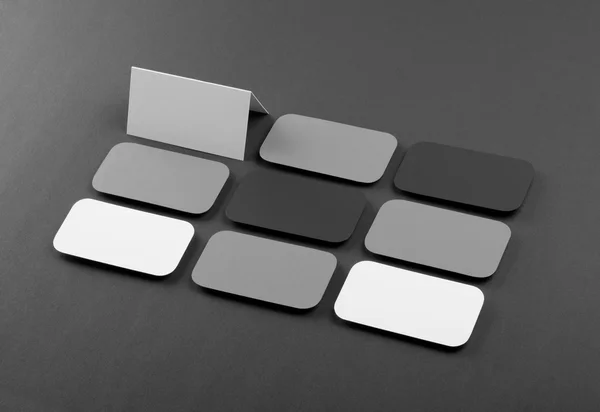 Blank business cards with rounded corners on a gray background