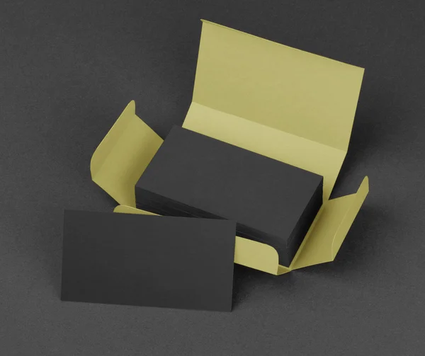 Black business cards in the beige box.