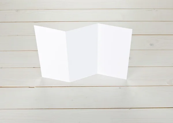 Blank folding page booklet on wooden background.