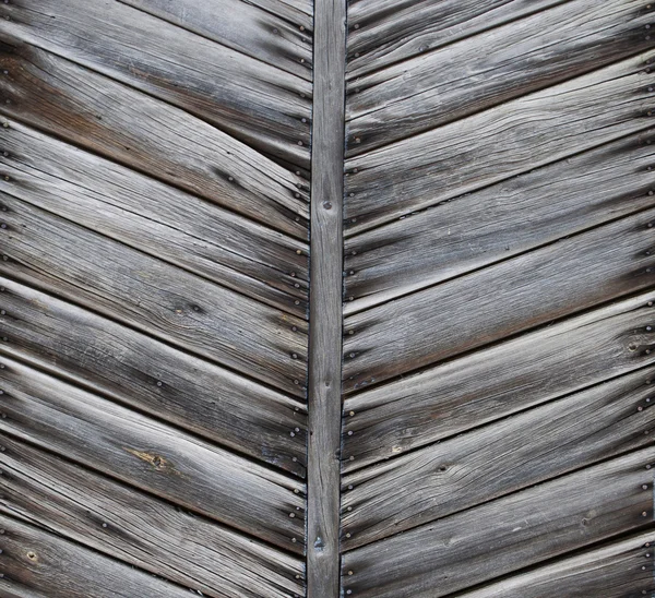 Old wooden gate detail with herringbone pattern.