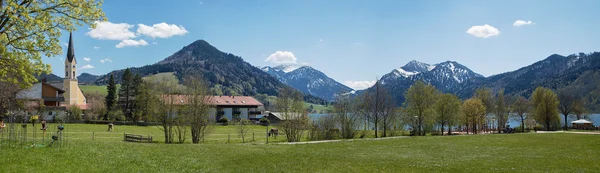 Idyllic spring landscape, spa town schliersee with green pasture