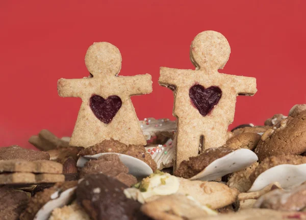 Christmas cookie couple, handmade wholemeal cookies on red backg