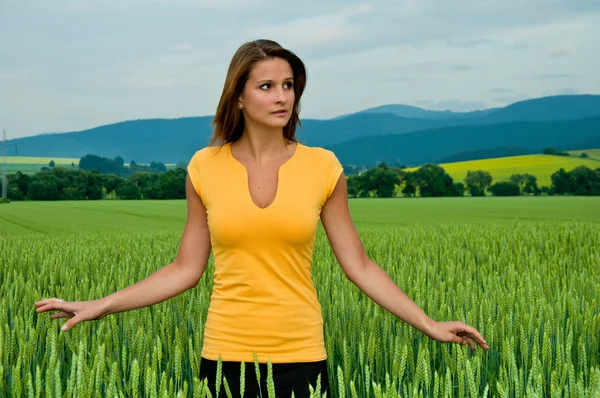 Lady in green field of corn