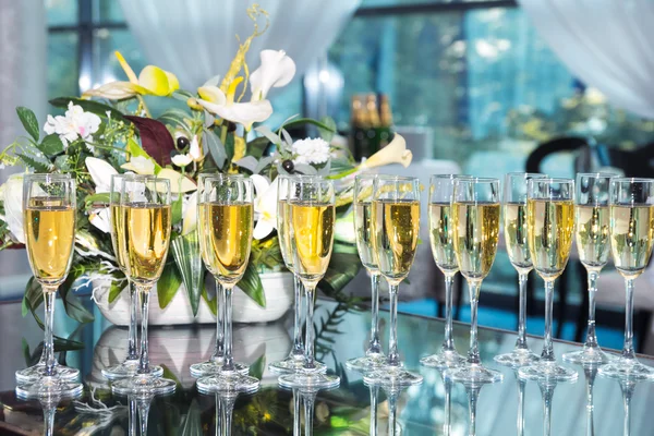 Elegant glasses with champagne standing in a row