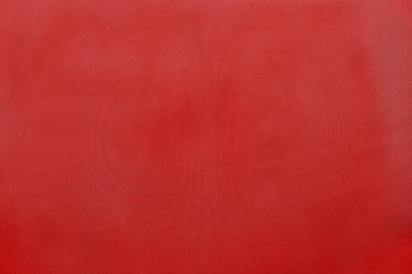 Grained textured background from fabric of bright red monochrome color