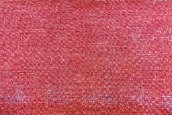 Rough texture old textile material of red color with attritions