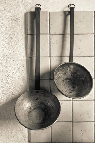 Kitchen ware or the utensils for frying on wall closeup