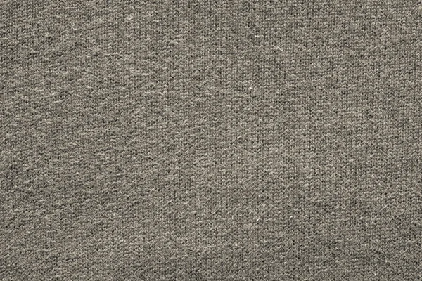 Texture from a wool yarn of beige gray color