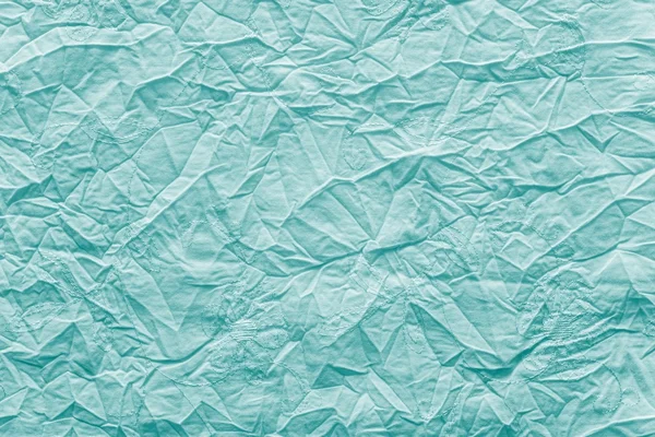 Crumpled texture fabric of bright turquoise color