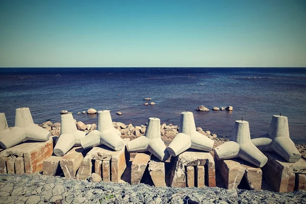 Breakwaters on the bank sea in a retro tones