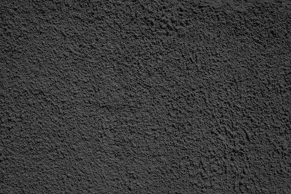 Rough texture plastered surface of black color