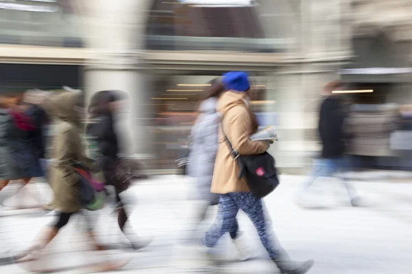 A shopper walking in front of shop window