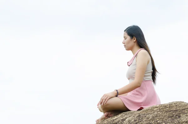 Woman meditation on the mountain.