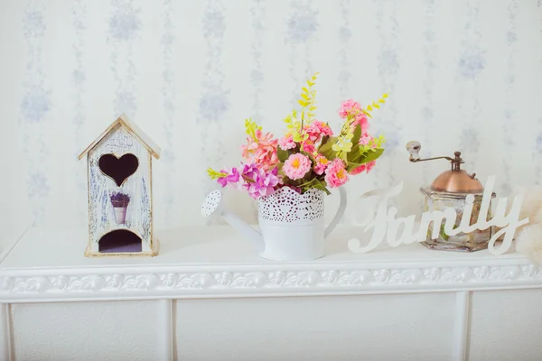 Home decor spring. Grinder and a vase of spring flowers in the style Shabby chic. White label family