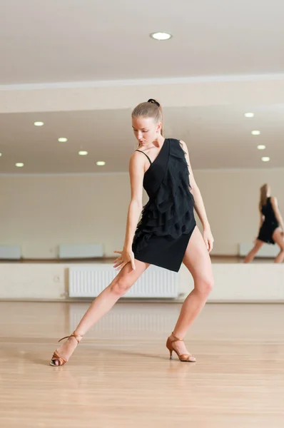 Young girl doing exercises in a dance class