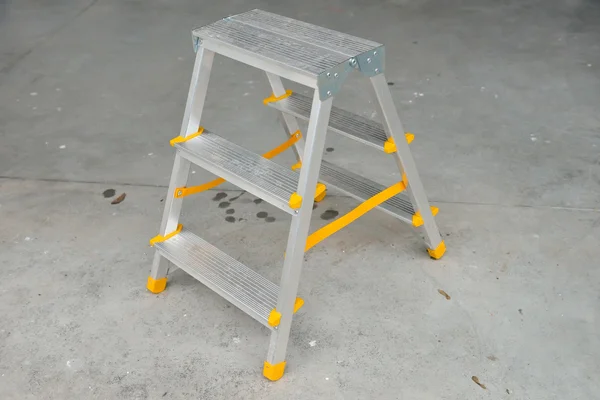 Picture of a small foldable ladder on sidewalk