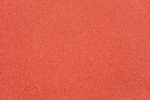 Red rubber floor on playground. Background detail