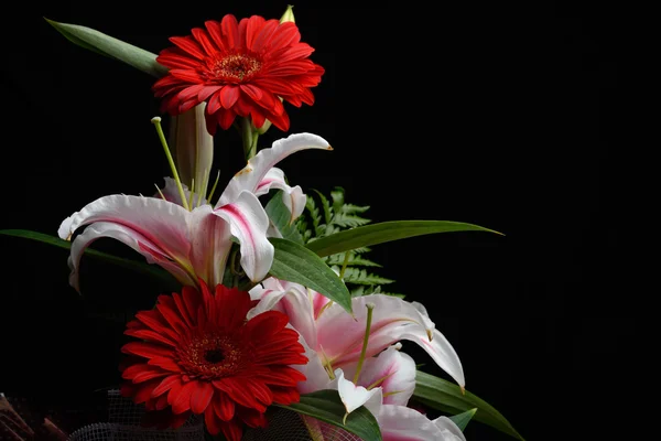 Beautiful bouquet made from red gerbera and white lilies put to