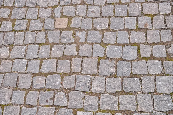 Old grey pavement in a pattern in an old medieval european town.