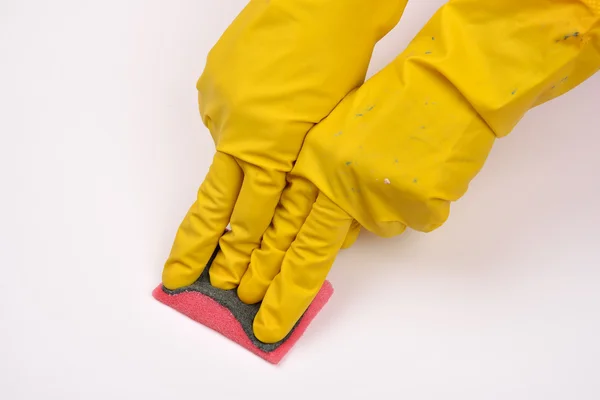 Women protecting hand with rubber glove from detergents as they