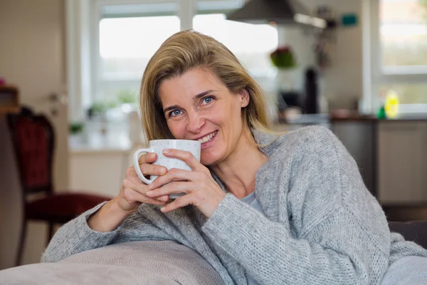 Woman in living room with coffee