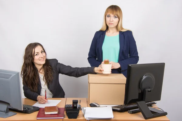 Office worker happily helps collect things sacked colleague