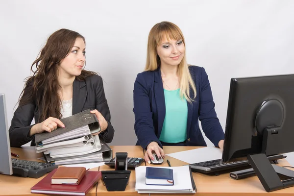 Office employee asks for help from colleagues at work with papers and documents