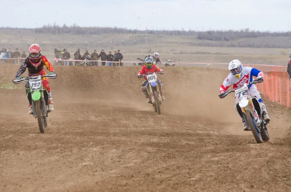 Volgograd, Russia - April 19, 2015: Three riders on the track, at the stage of the Open Championship Motorcycle Cross Country Cup Volgograd Region Governor