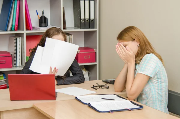 The girl was crying at the reception office worker covered his face with papers