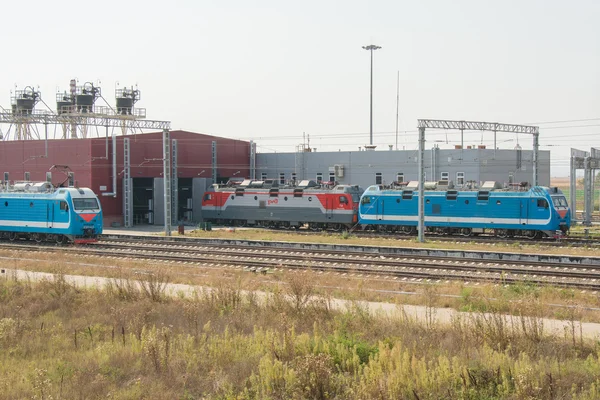 Locomotives trains stand at the gate of the locomotive depot